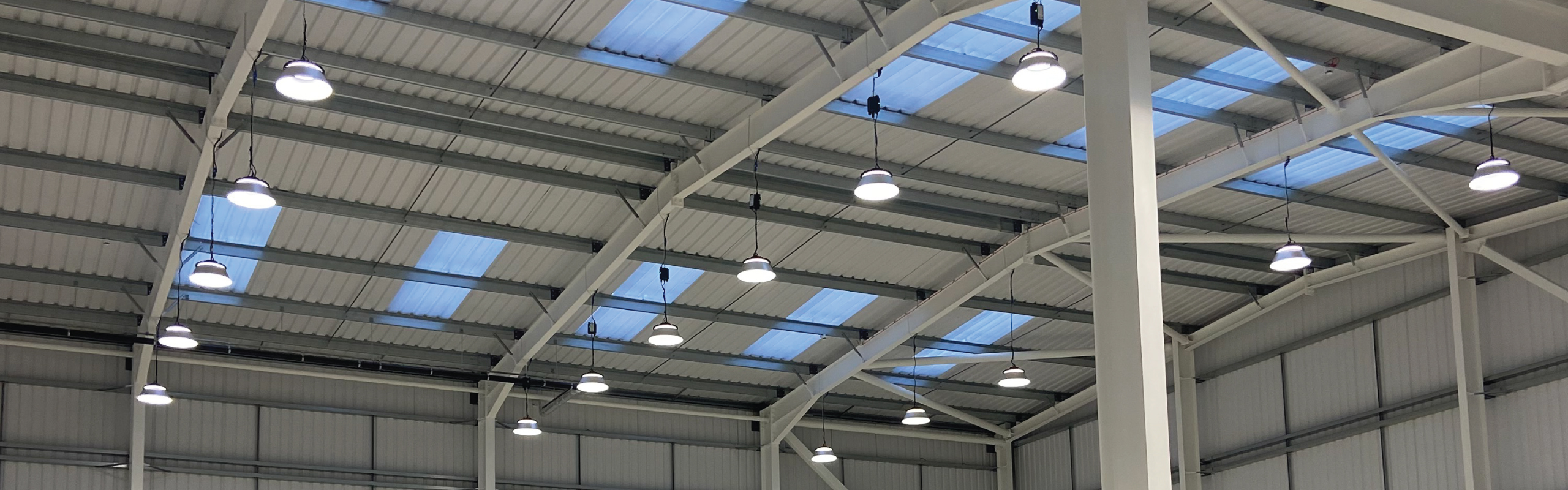 New warehouse LED lighting installation using smart occupancy sensor lighting controls to improve energy efficiency