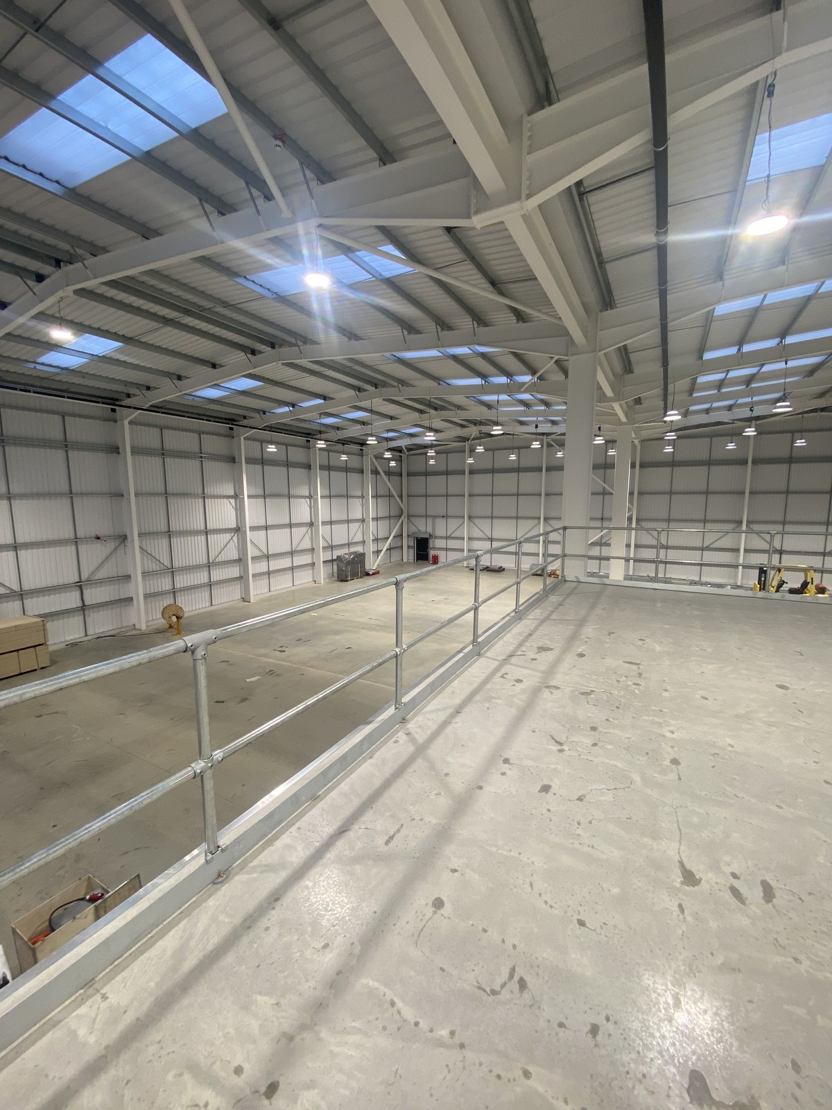 COM200-CCT LED high bay lights illuminating a newly installed warehouse space