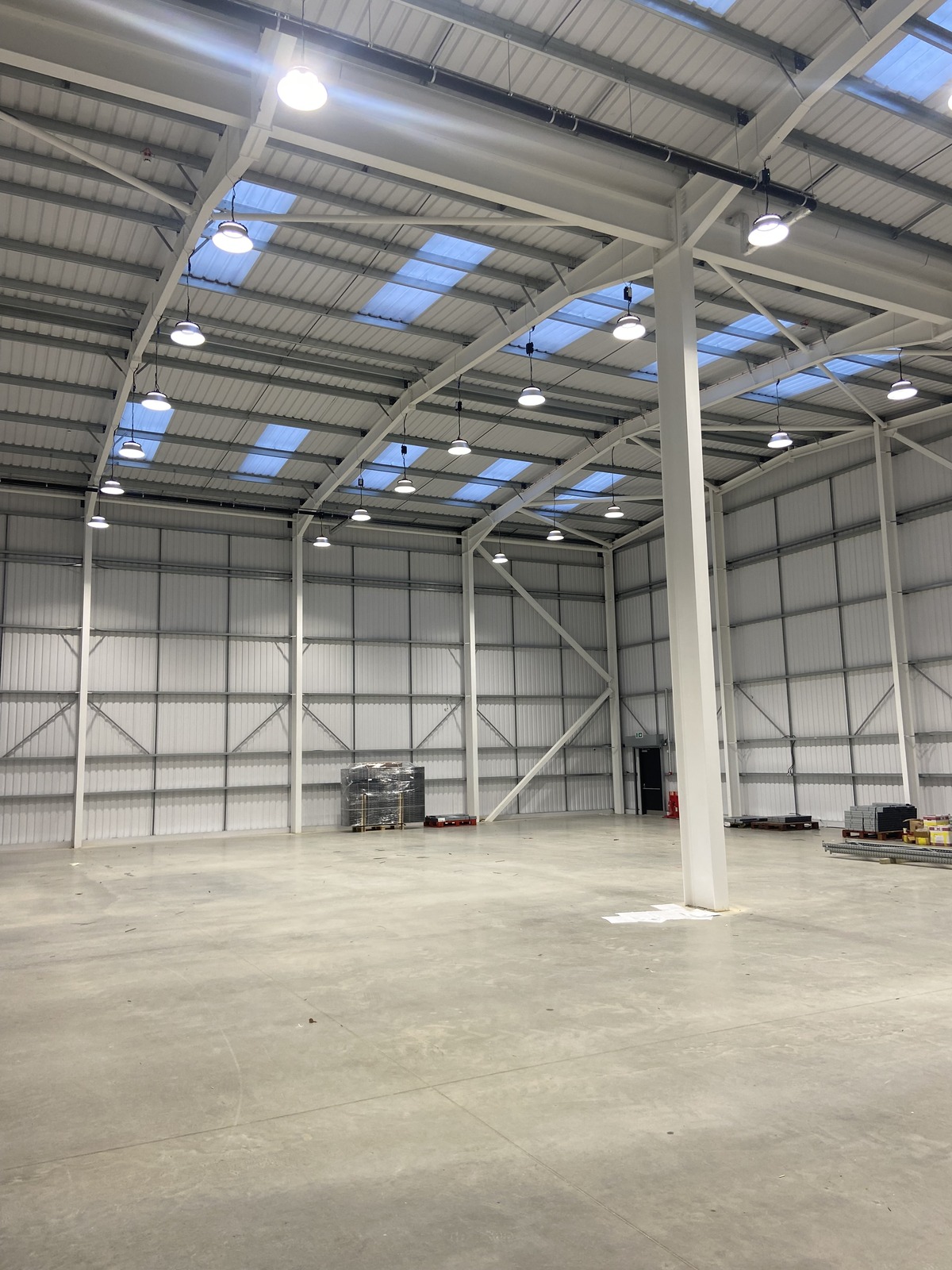 Emergency conversion kit fitted to LED high bay lighting in a new warehouse installation