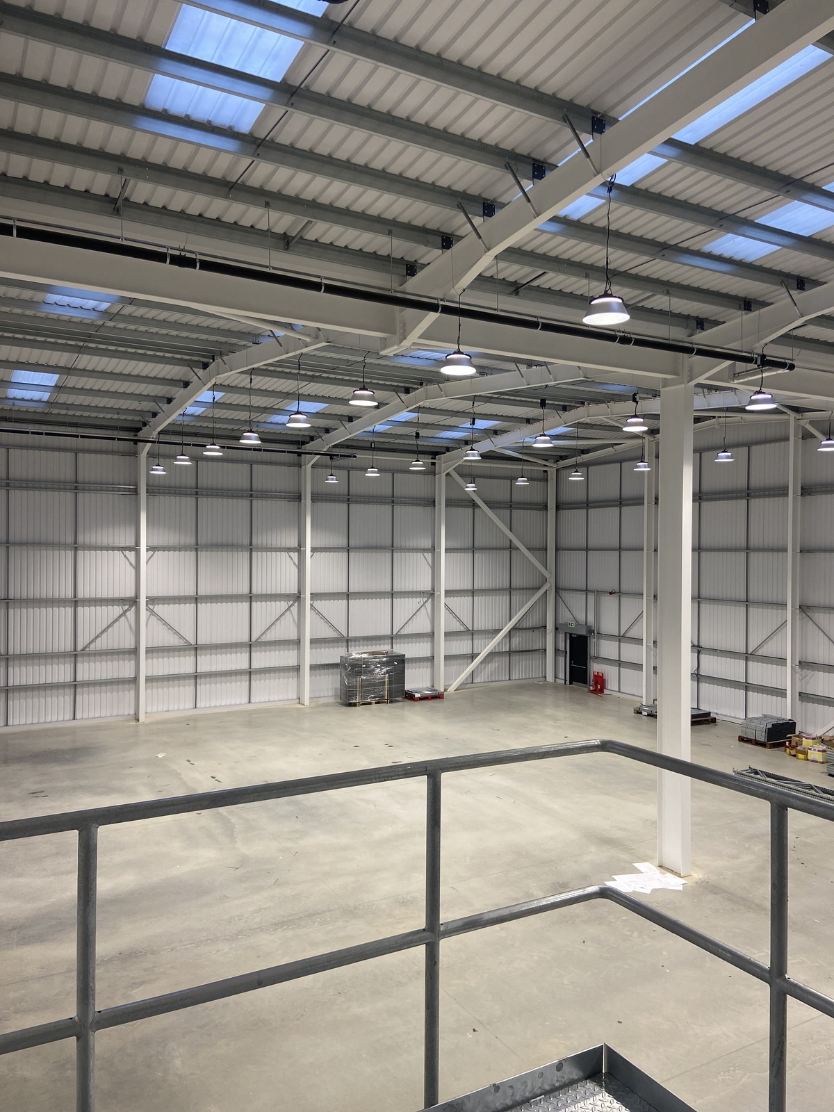 Wide angle view of completed LED high bay lighting installation across Capital Angling warehouse